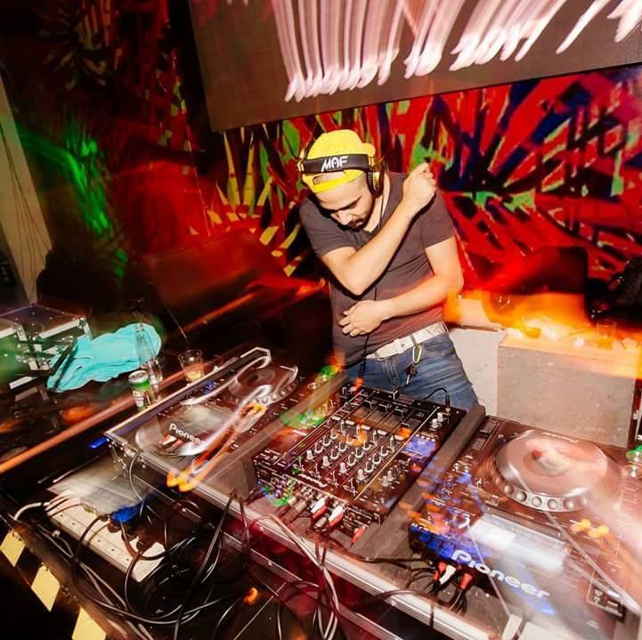 VDJ Maf on vinyl turntables at a formal event in suit